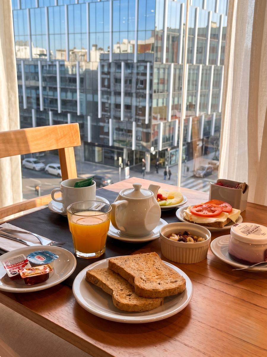 Breakfast served at a table by the window overlooking the street
