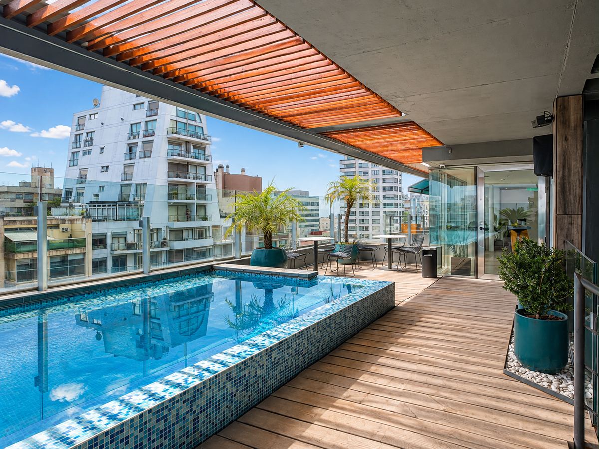 Rooftop terrace with a pool and a wooden pergola on the 14th floor